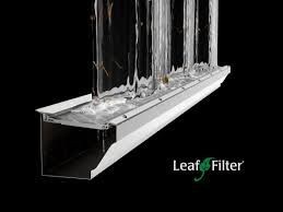 Leaf Filter gutter system with water flow demonstration on black background.